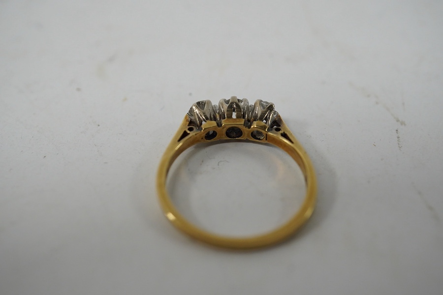 An 18ct gold and three stone diamond set ring, size K, gross weight 2.4 grams. Condition - fair to good